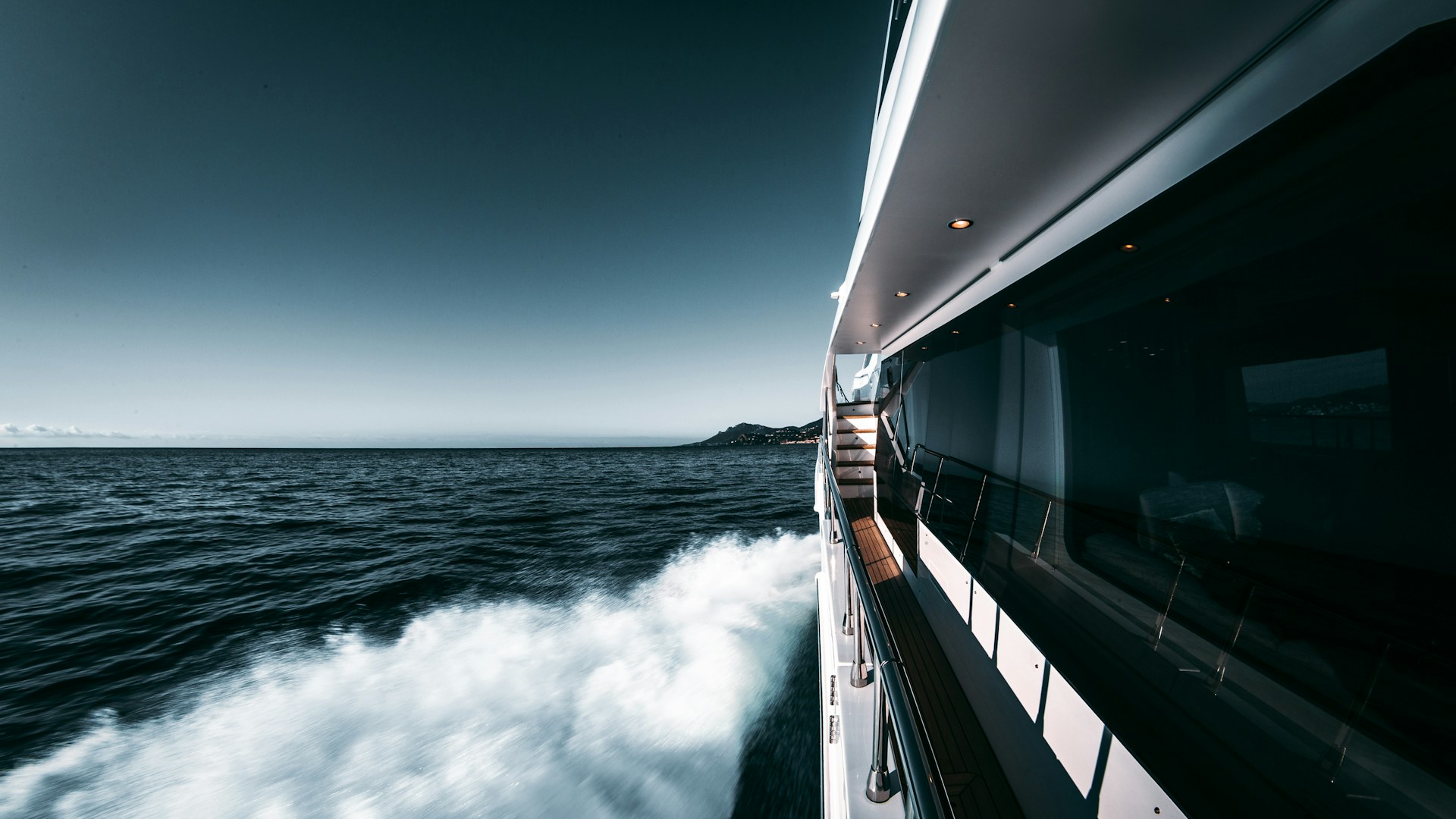 Custom-built motor yacht anchored in a cove