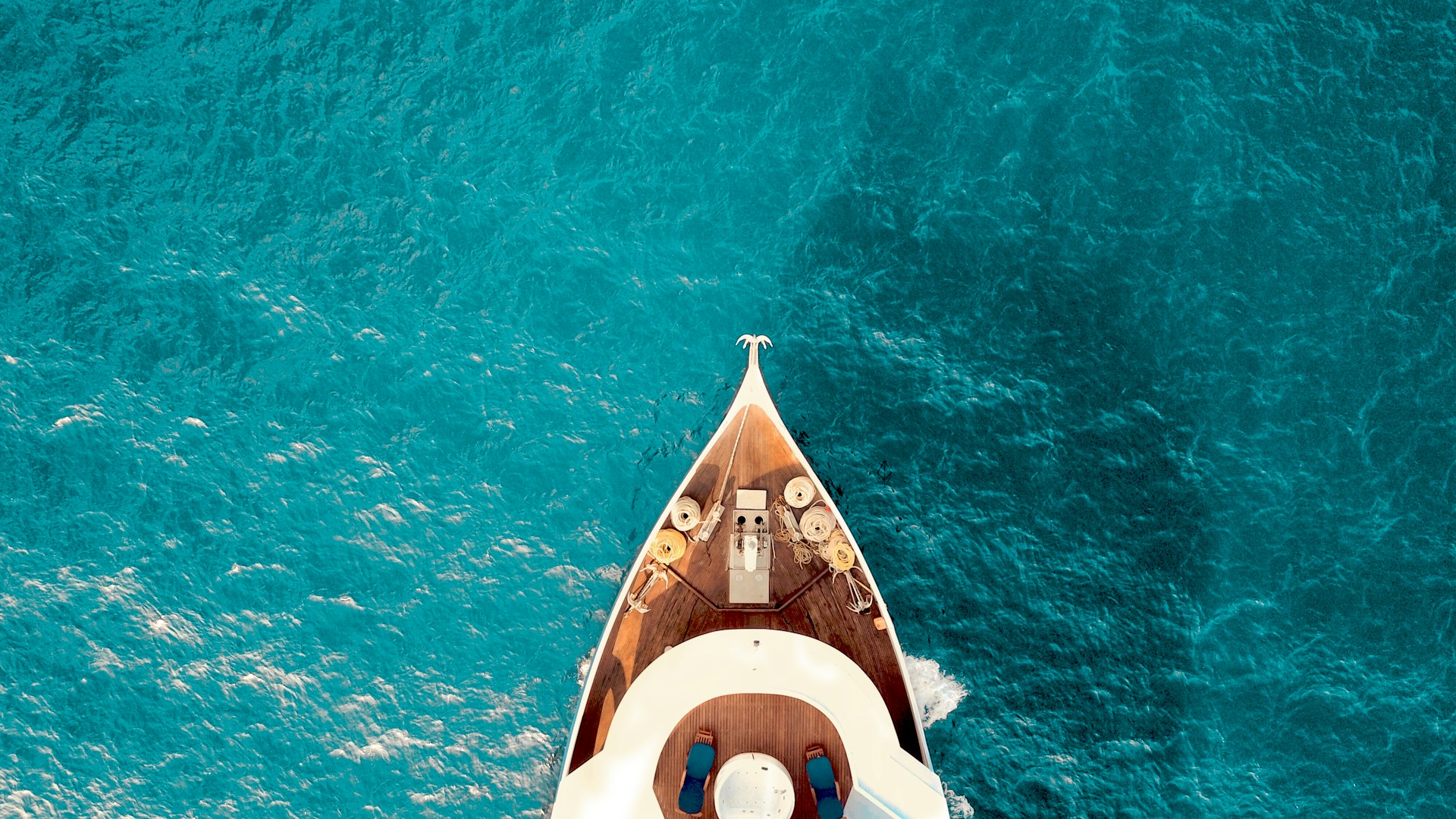 Aerial view of a yacht bow in turquoise water